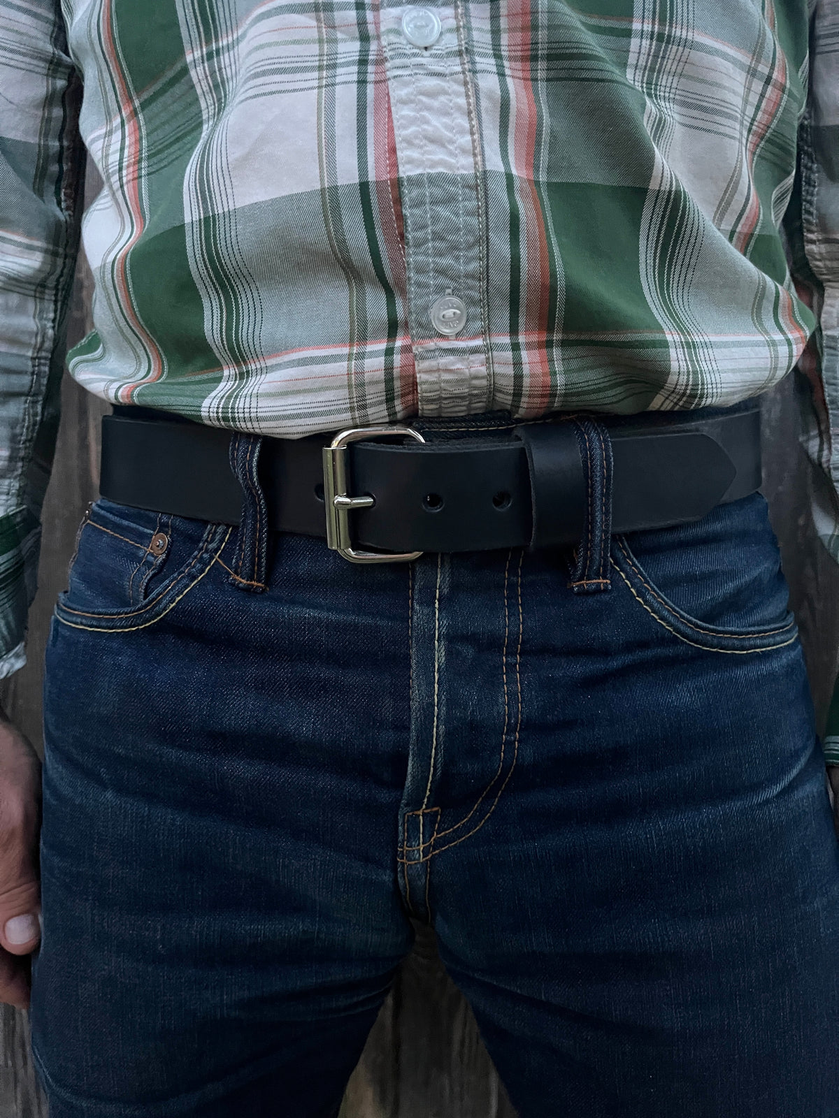 man wearing a black leather belt