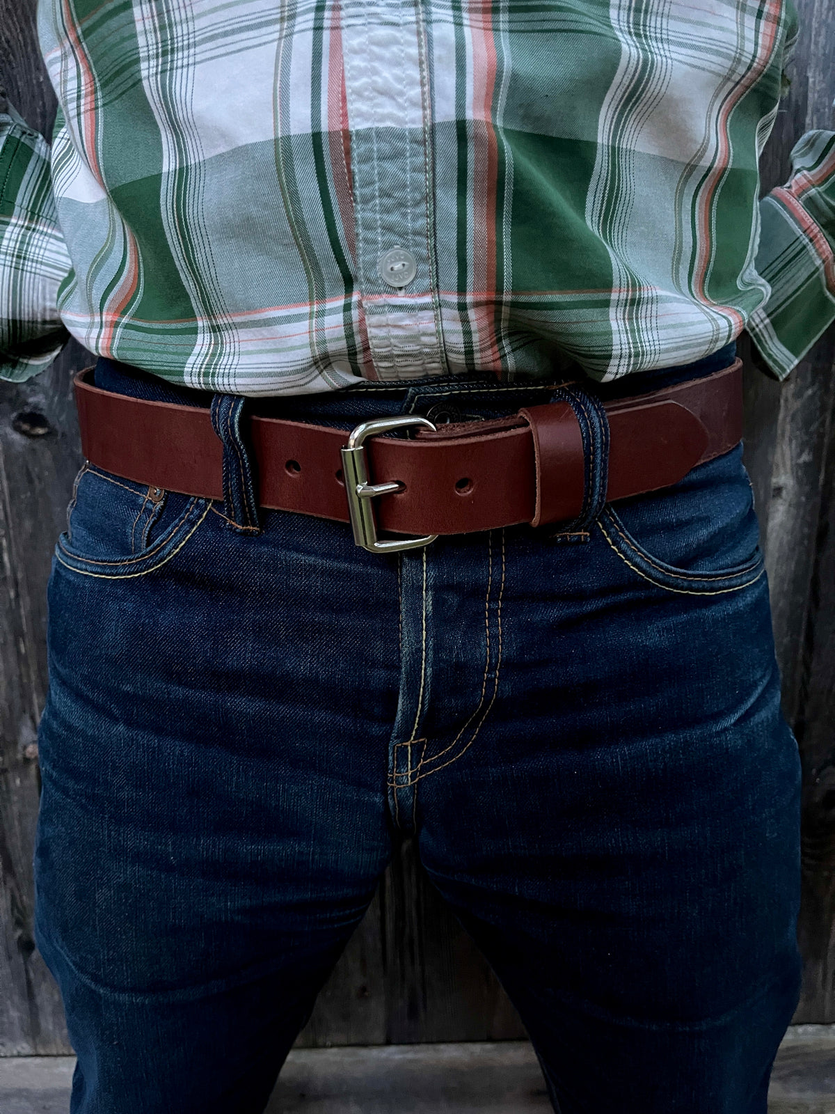 man wearing a brown leather belt
