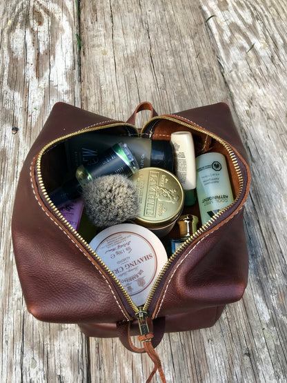 Brown leather Dopp kit opened
